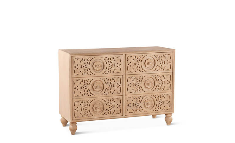 a dresser with intricate carvings in a natural wood finish